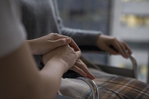 A therapist working with an injured worker’s hand.