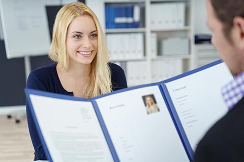 A vocational counselor reviewing case files.